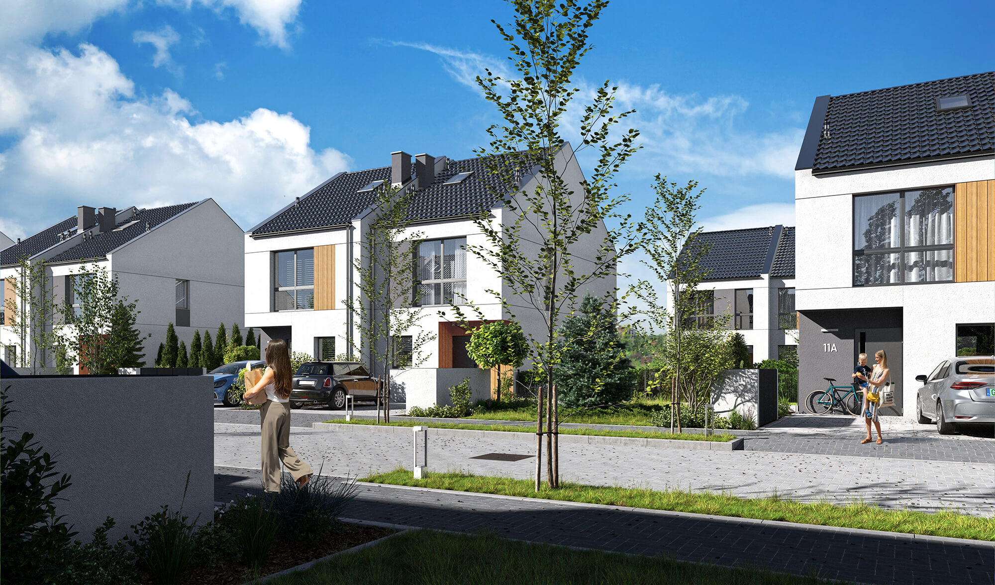 Osiedle z budynkami bliźniaczymi z jasną elewacją z elementami drewna.