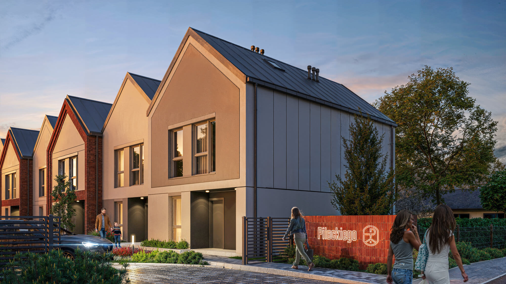 Wjazd na osiedle o zachodzie słońca.