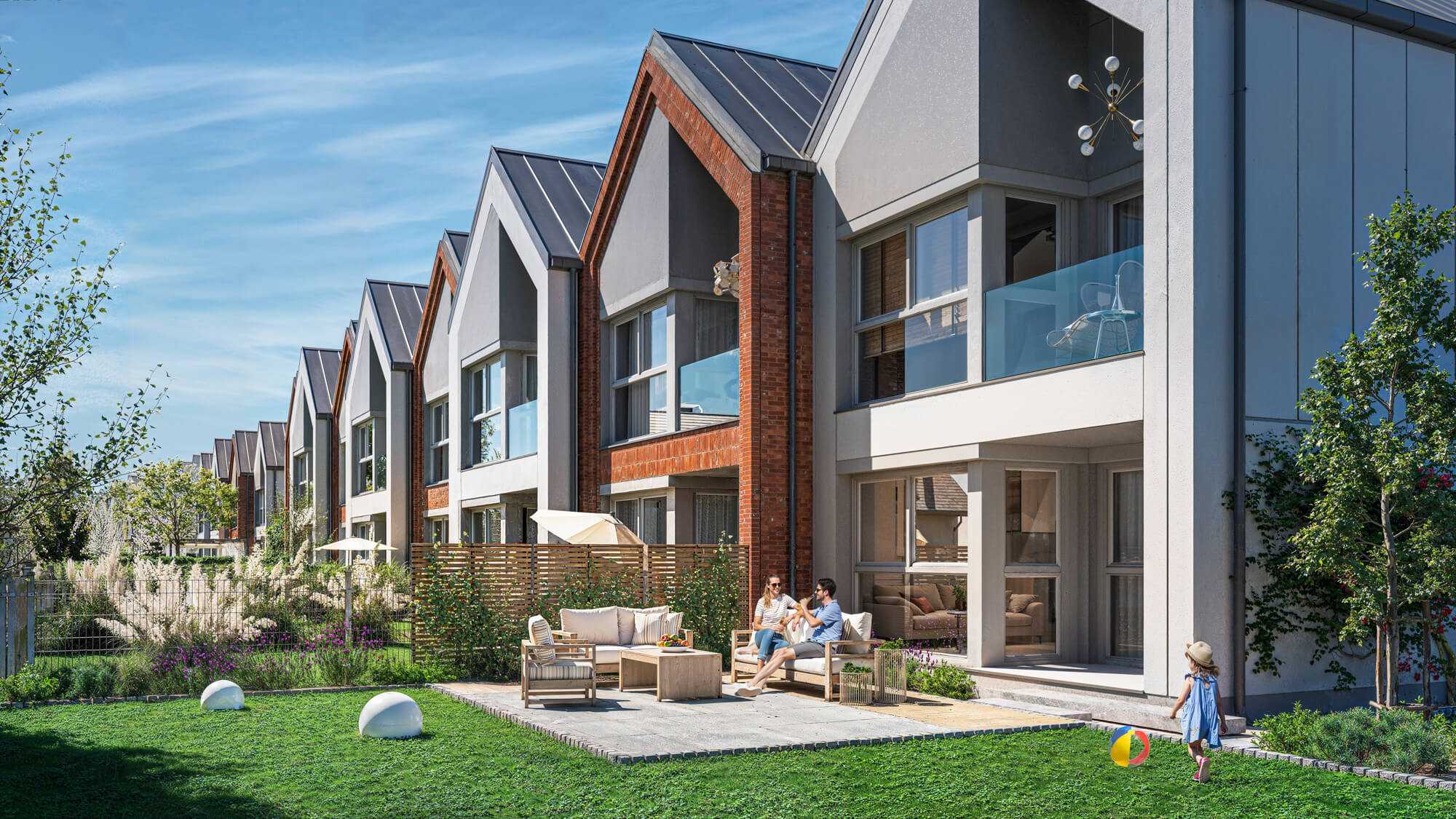 budynek szeregowy z tarasem i ogrodem w słoneczny dzień.